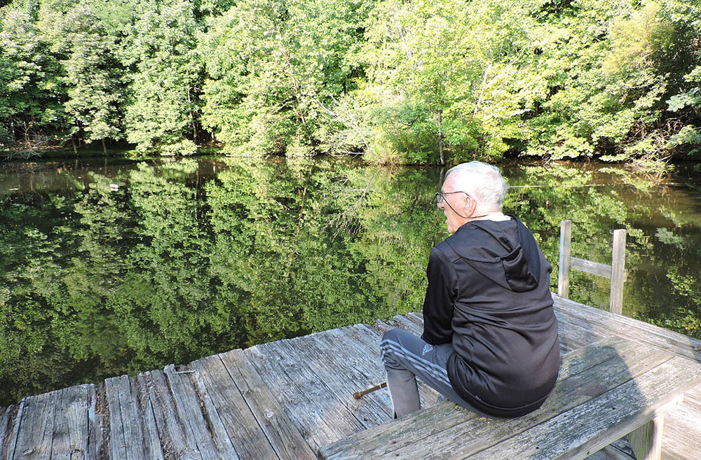 Carl Siebentritt looks out at pond