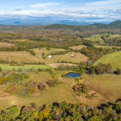 an aerial mosaic of rural land with a blue pond
