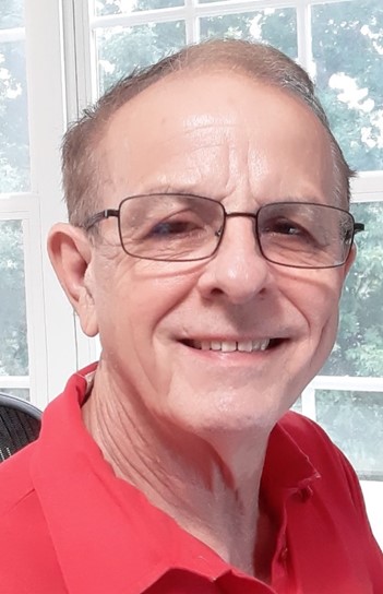 A man smiles at the camera.