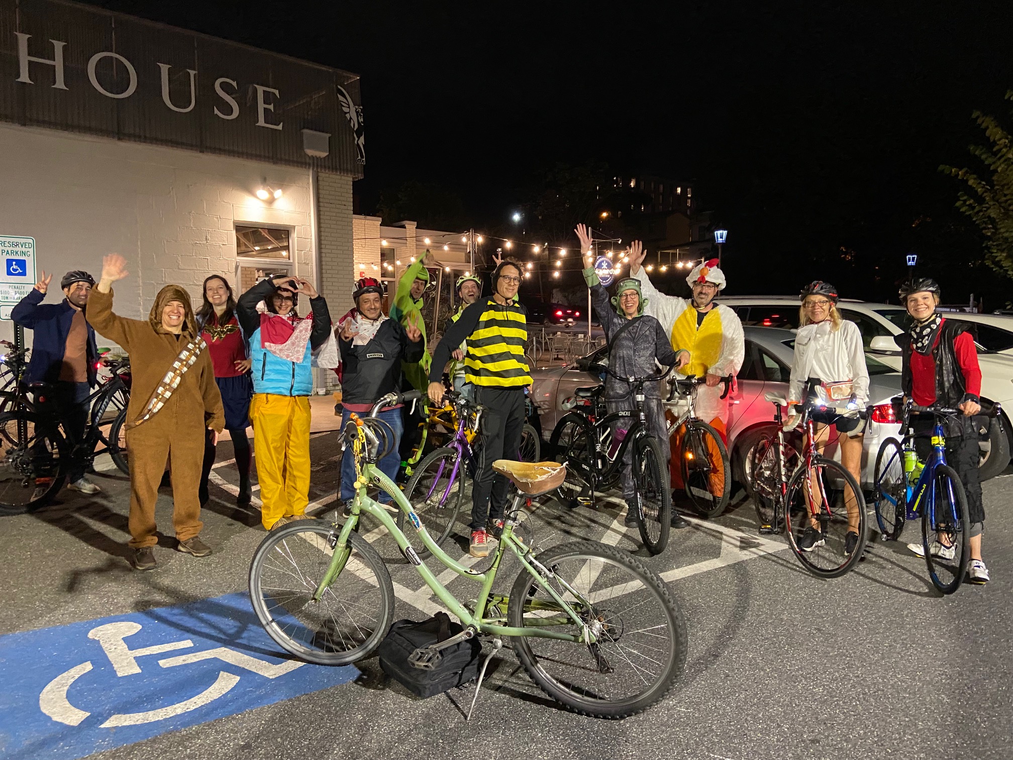 a group of bikers wearing festive Halloween costumes in a parking lot