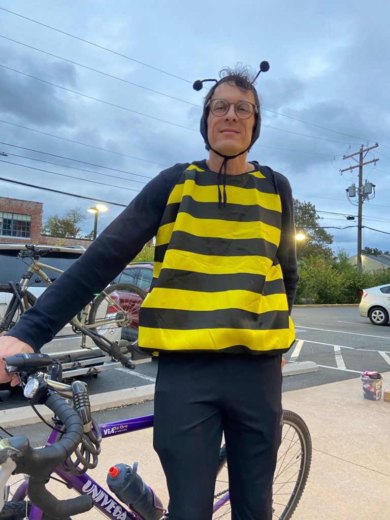 a man in a bumblebee costume with a bike
