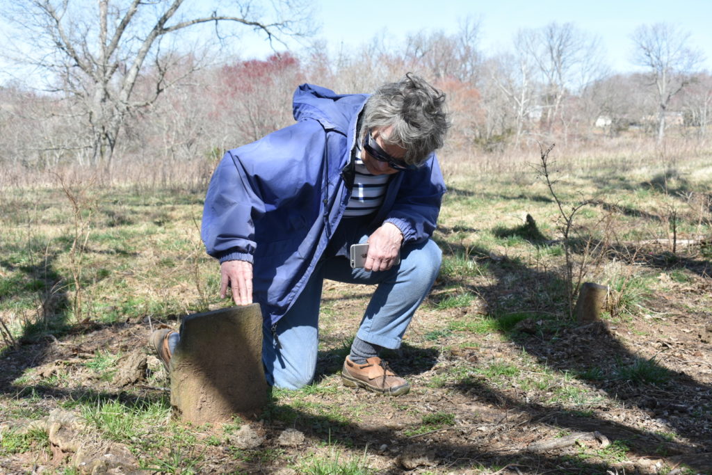 Judy Mahanes looks at headstone