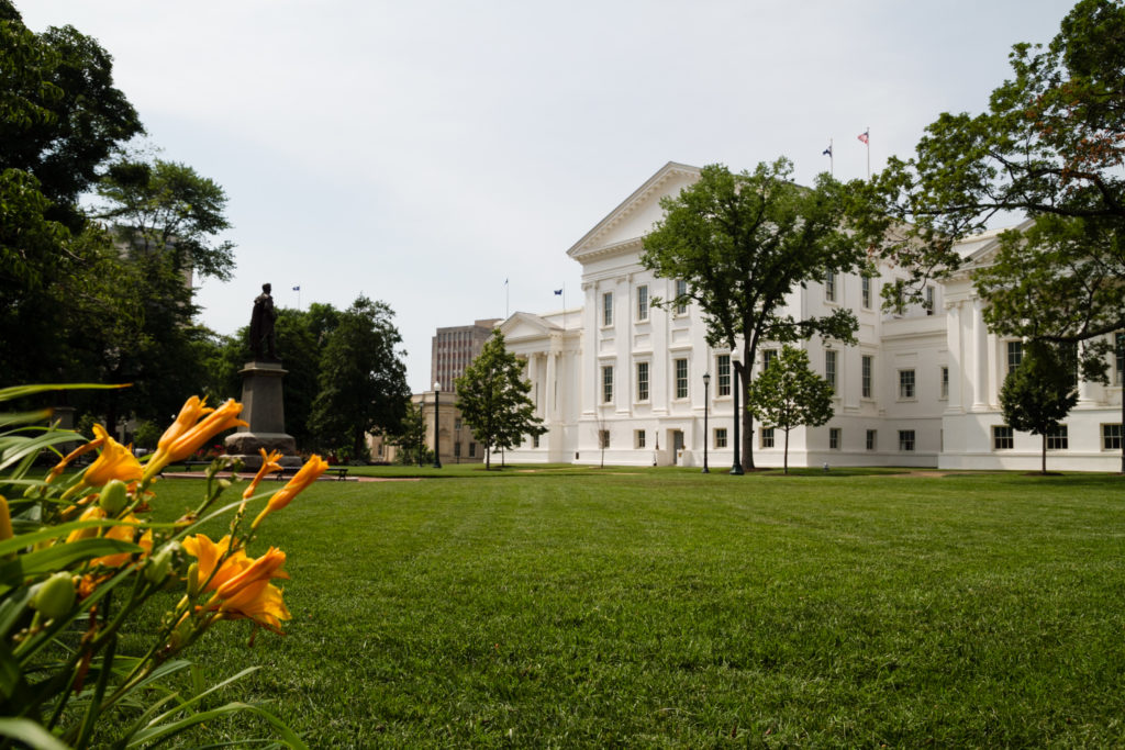 image of a green lawn with a large white building