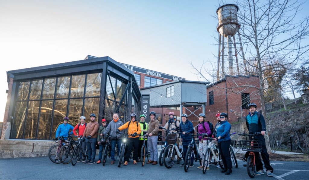 Cyclists pose in front of building in Charlottesville, Virginia
