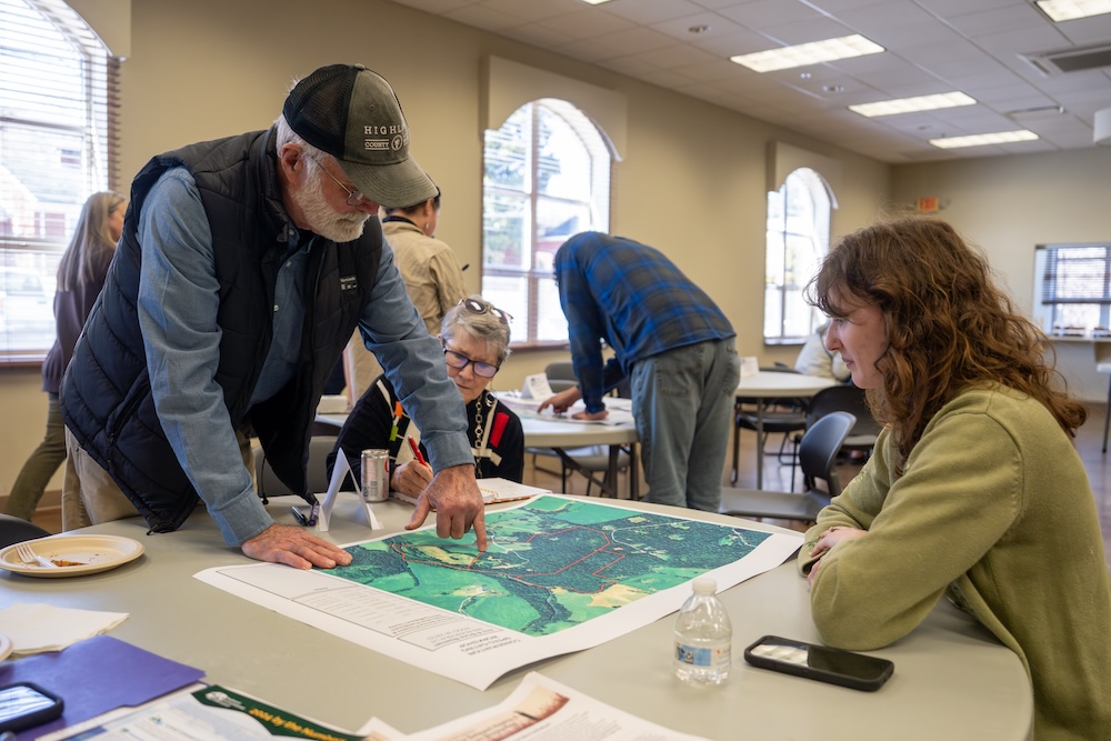 People discussing a large map.