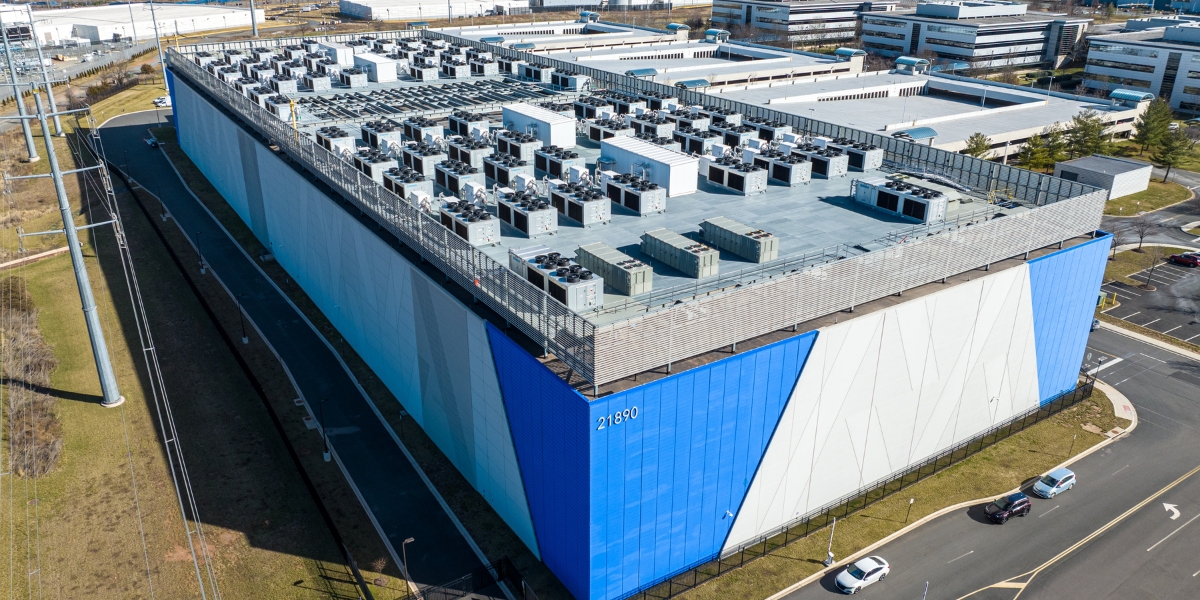 large boxy data center with cooling equipment on the roof
