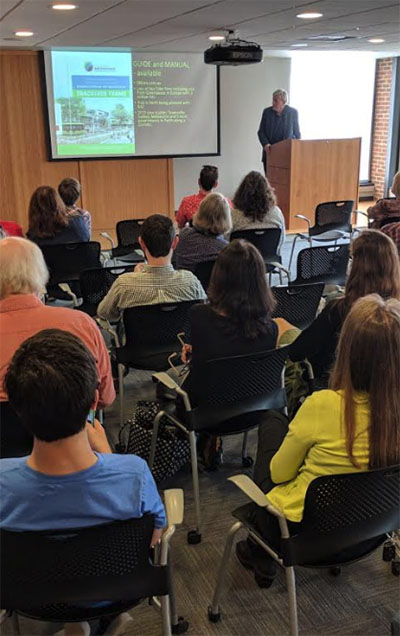 An audience looking at a projector screen.