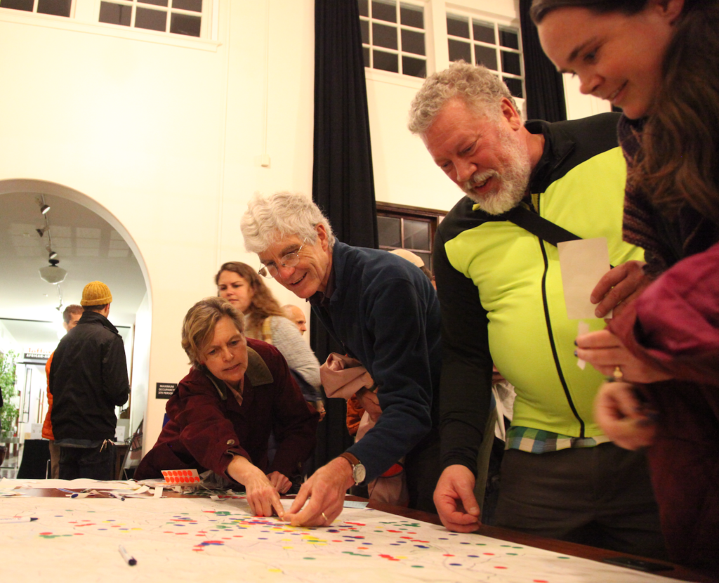 A group of people stand around a map.