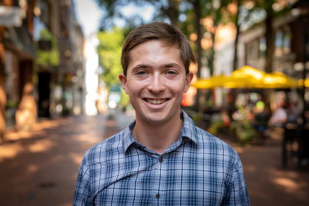 a young white man with a blurry background on downtown Charlottesville