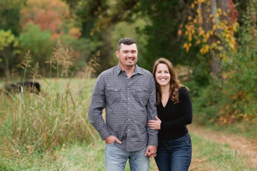 a couple stands on a rural property