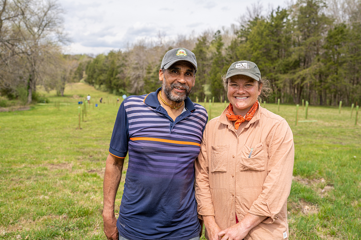 a man and woman stand side beside on a farm property