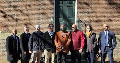 A group photo in front of a brick building.