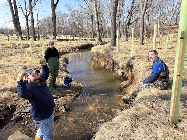 People working near a stream.