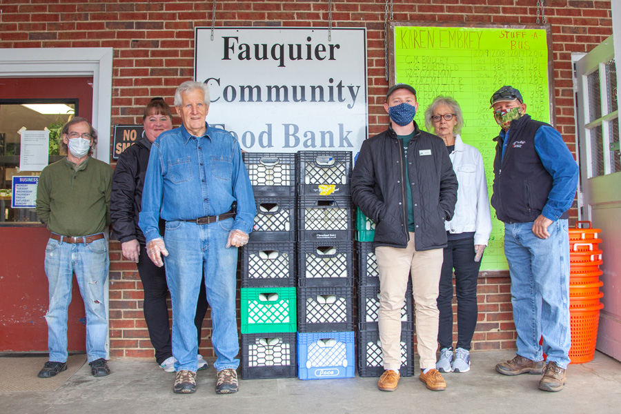 A group of people stand outside a food bank.