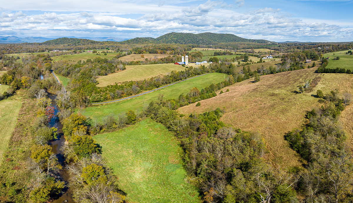 a river flows adjacent to rural properties