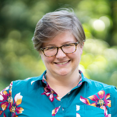 headshot of woman in blue shirt