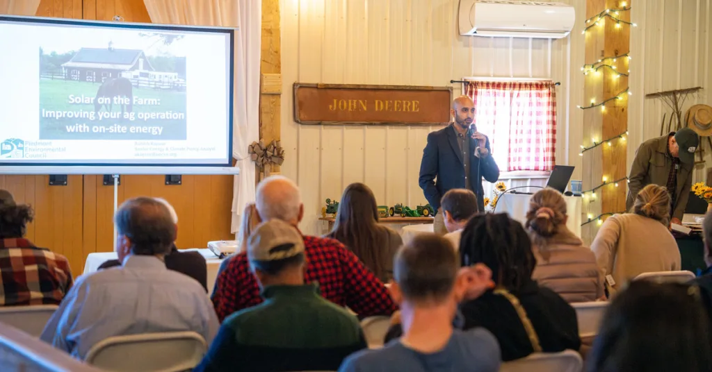 man giving a presentation in front of a crowd of seated people