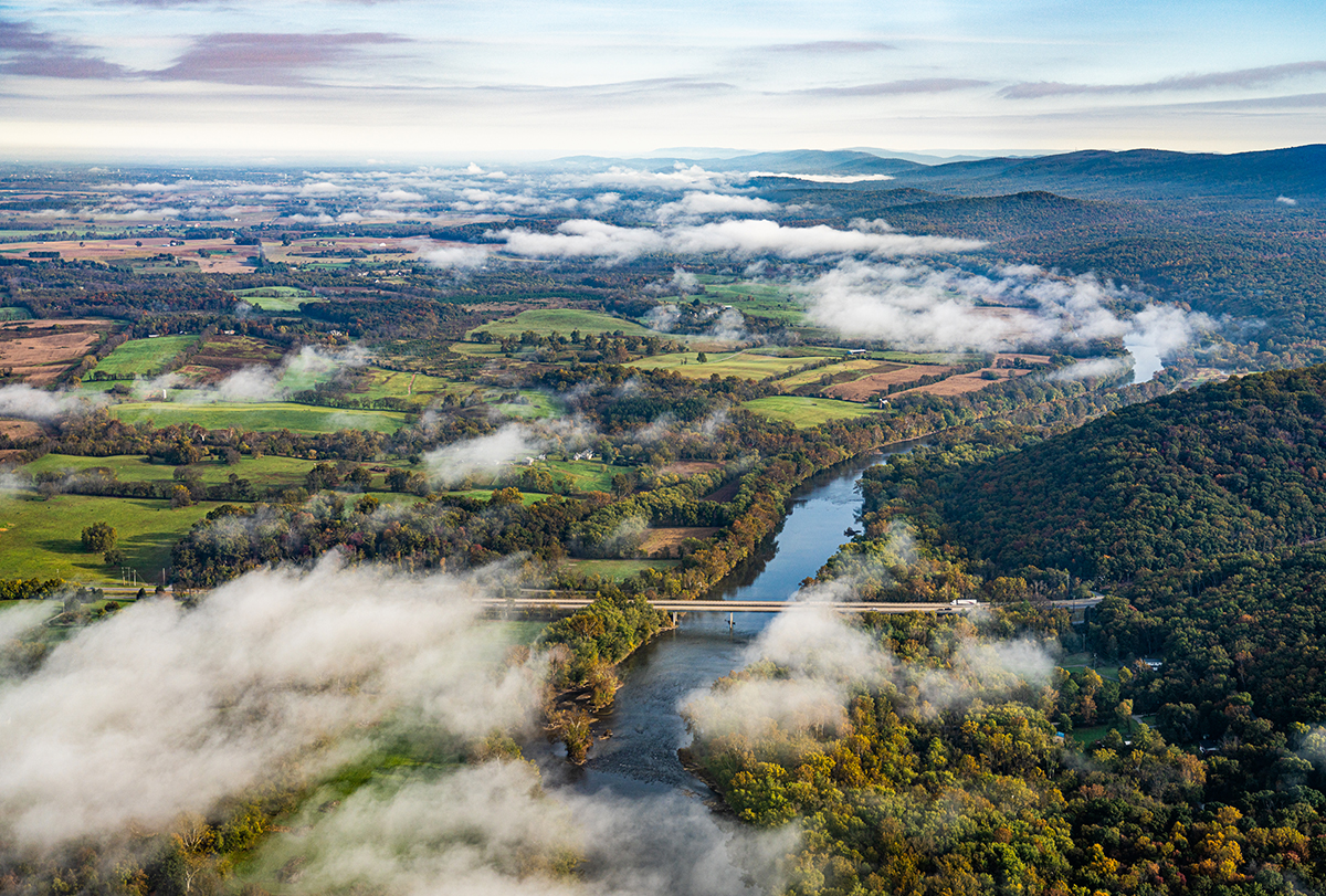 aerial image of the Shenandoah River cutting between mountains and rural land