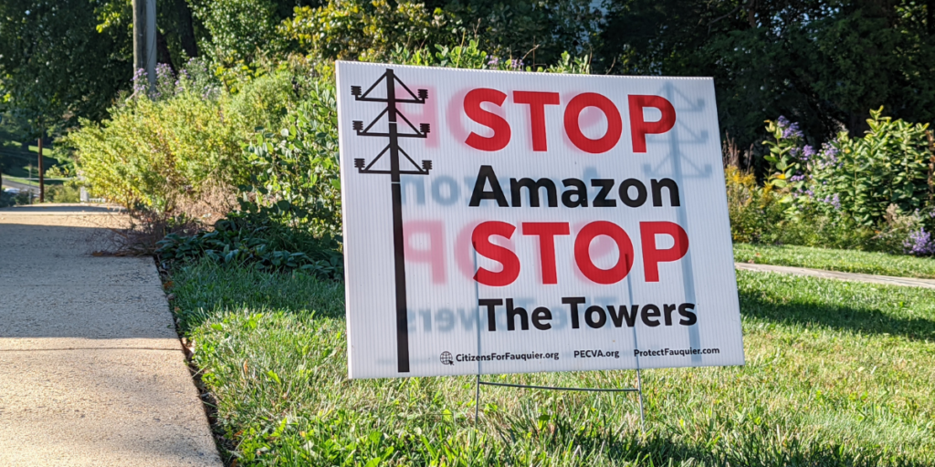 a yard sign that says "stop amazon stop the towers"