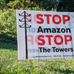 a yard sign that says "stop amazon stop the towers"