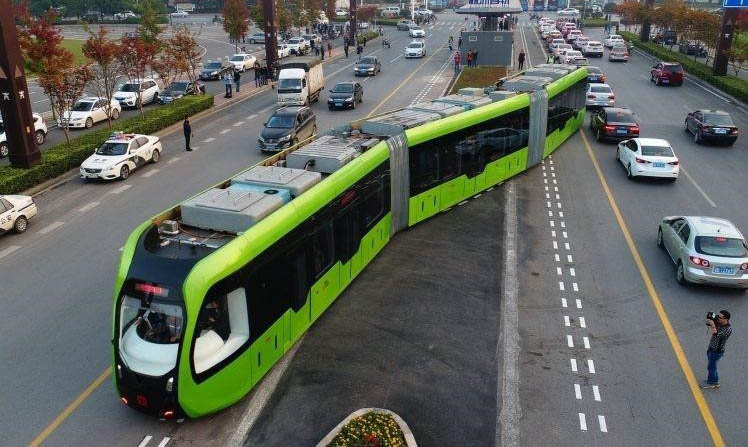 A trackless tram crossing a road.