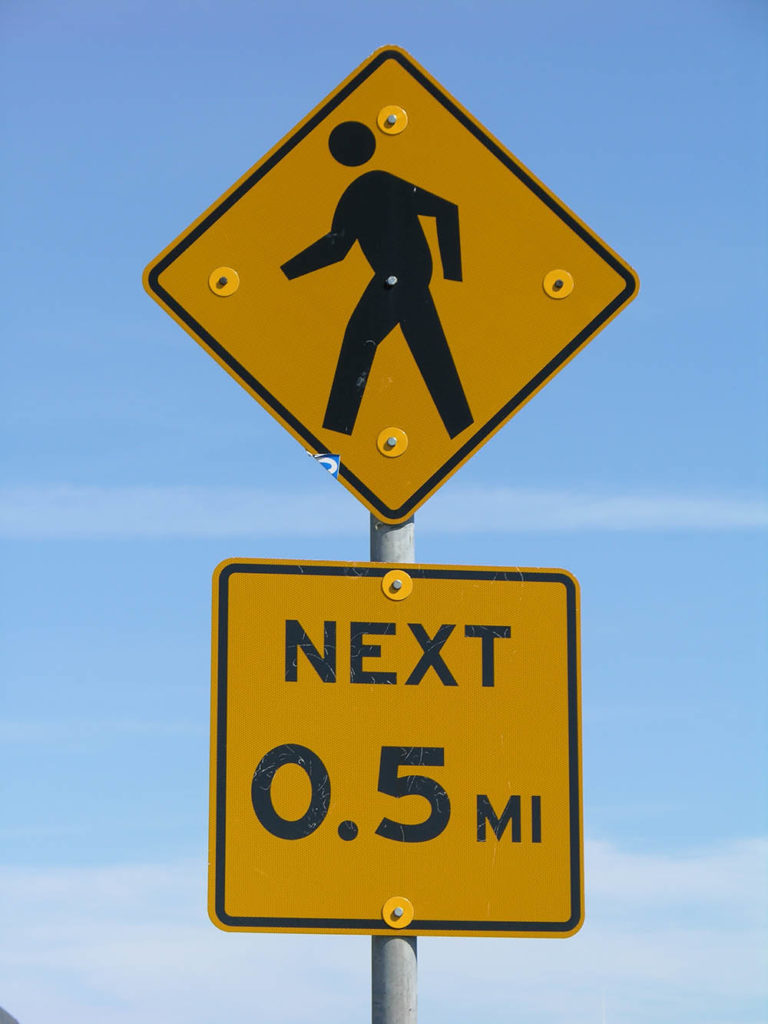 A pedestrian crossing sign.