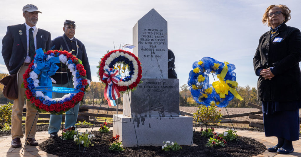 an obelisk Civil War memorial with patriotic wreaths