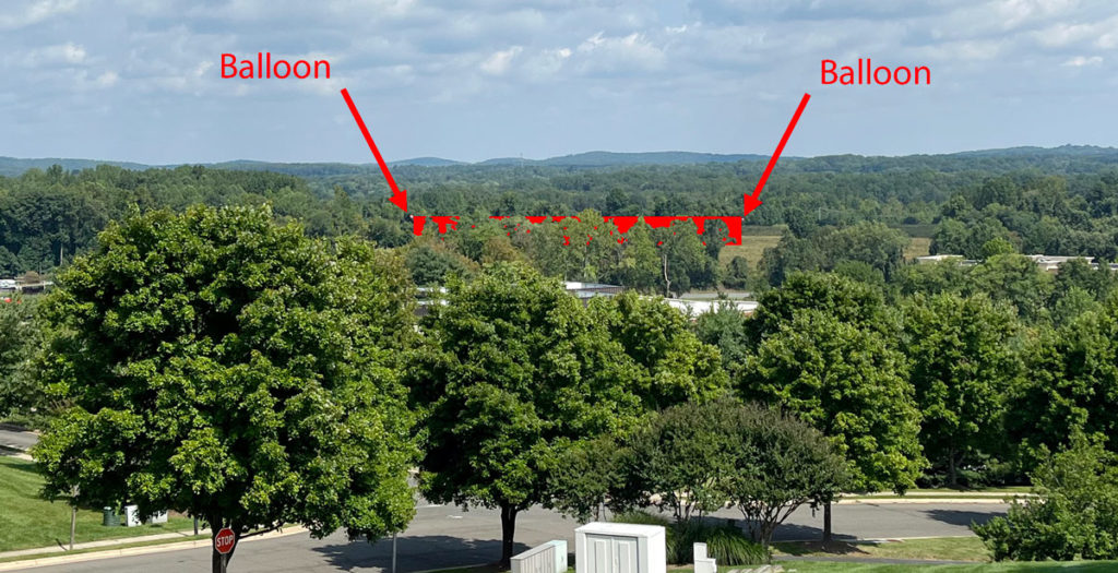 rendering of data center in distance between trees and fields